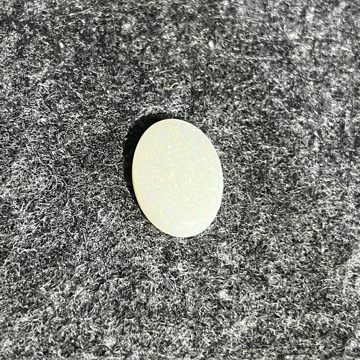 Natural Australian white opal, 5.15ct oval cabochon 16x12mm, milky body with a soft sheen