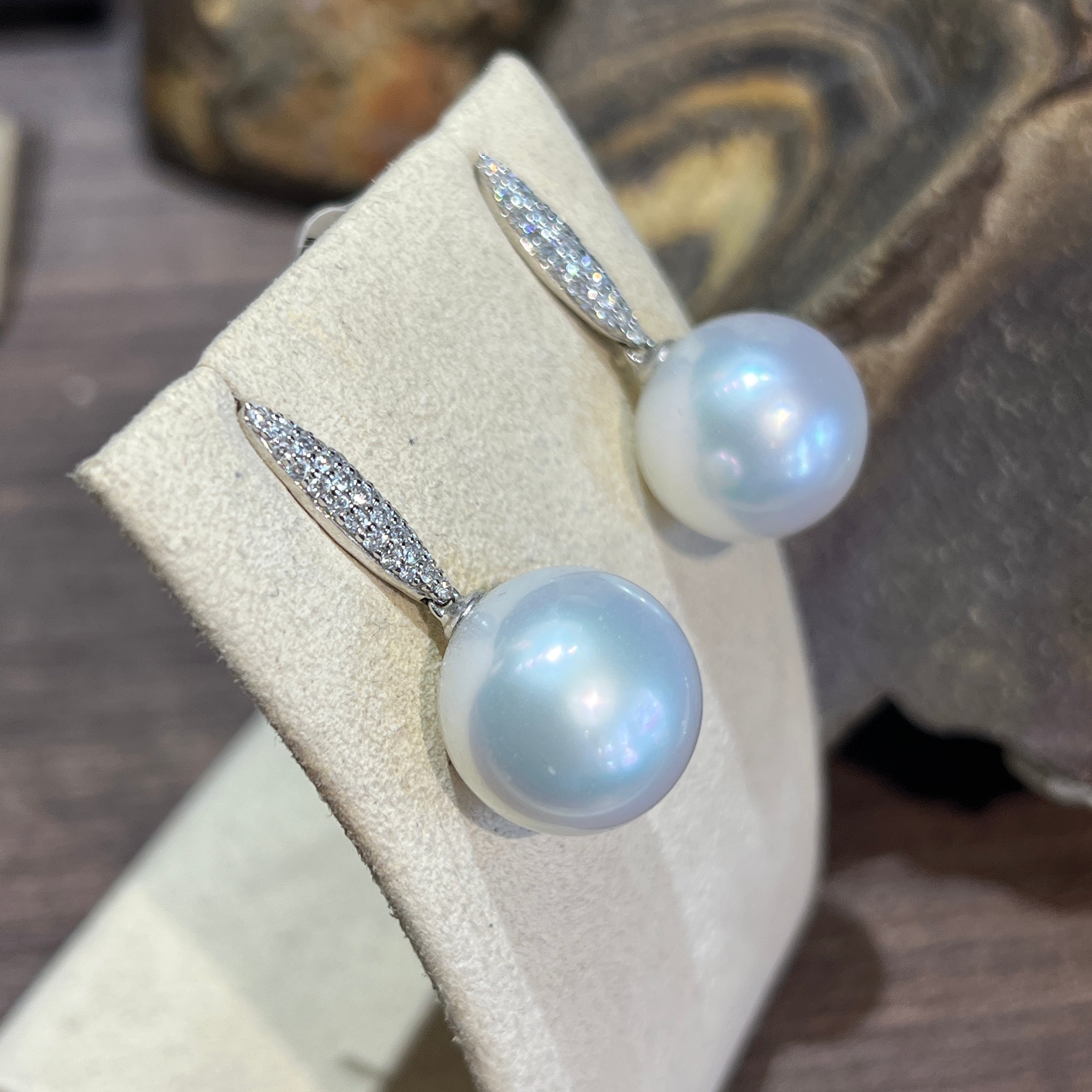 South Sea pearl drop earrings angled to show the pave diamond bar above each 15-16mm pearl