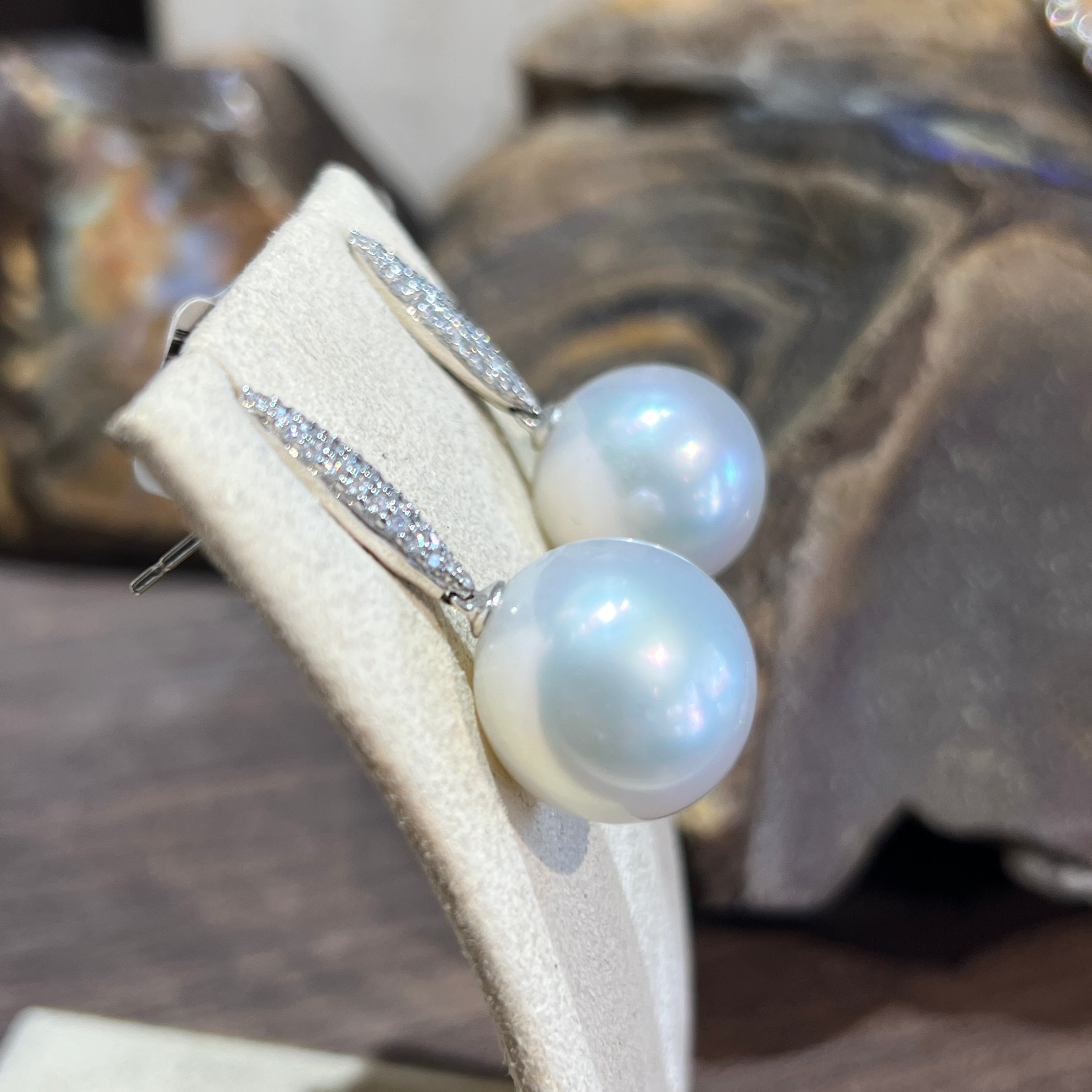 Side view of 18kt white gold South Sea pearl earrings, diamond-set bars and 15-16mm pearls