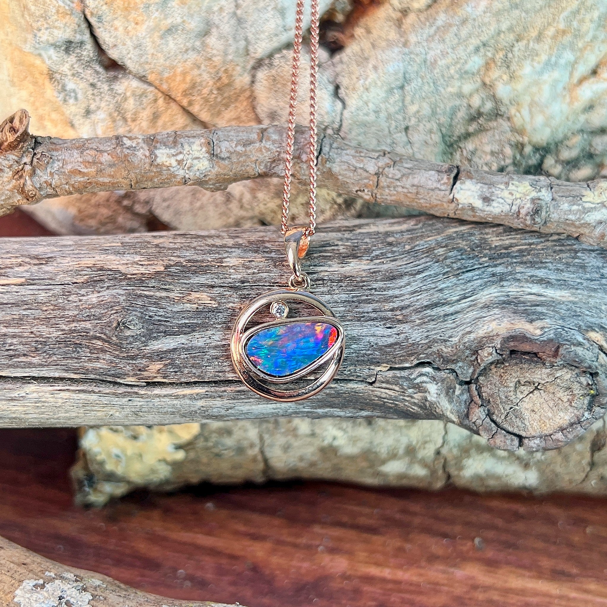 Australian opal doublet pendant, rose gold-plated silver, 12 x 11mm stone showing blue, yellow, green and red