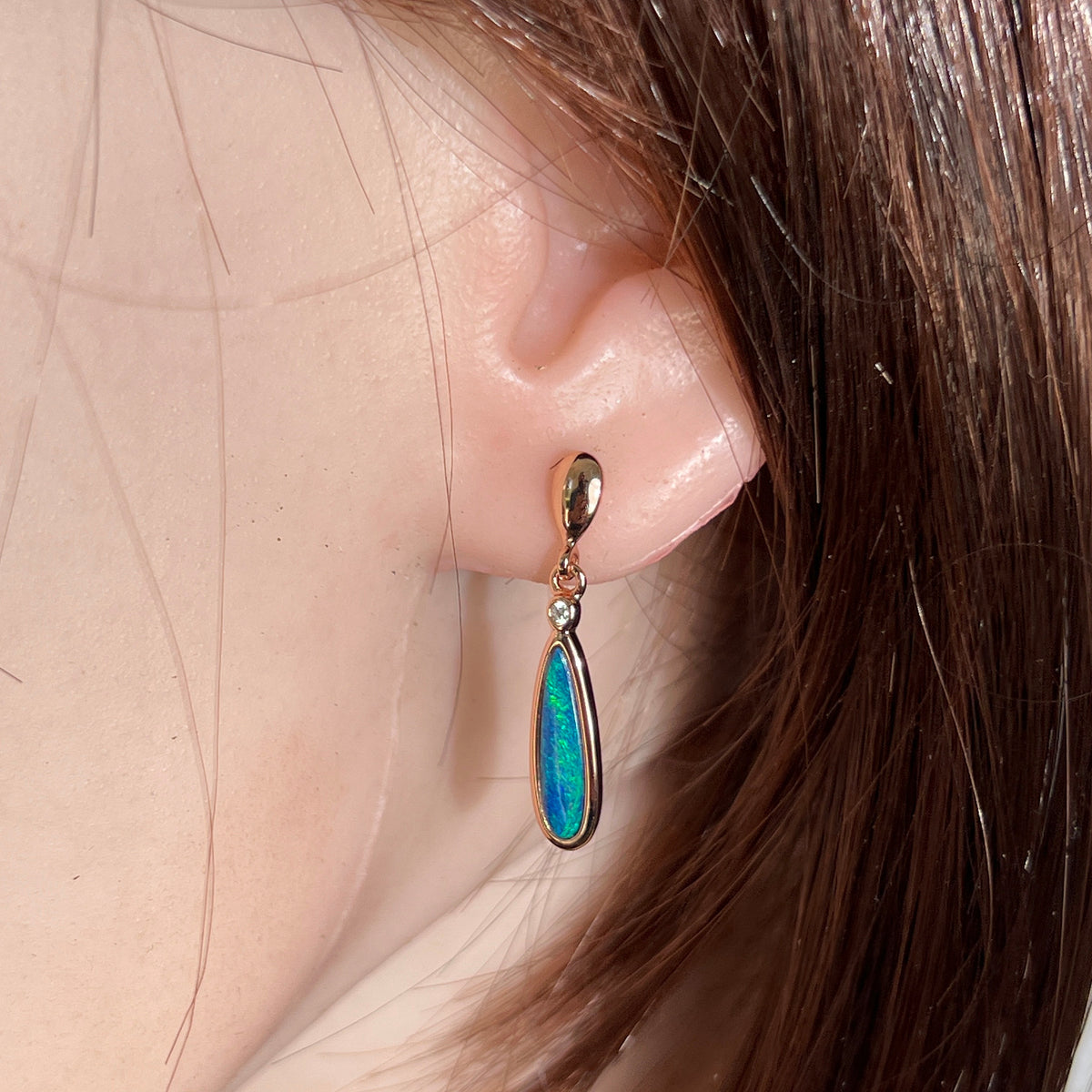Worn Australian opal doublet earrings in rose gold-plated silver, green and blue, 15 x 5mm