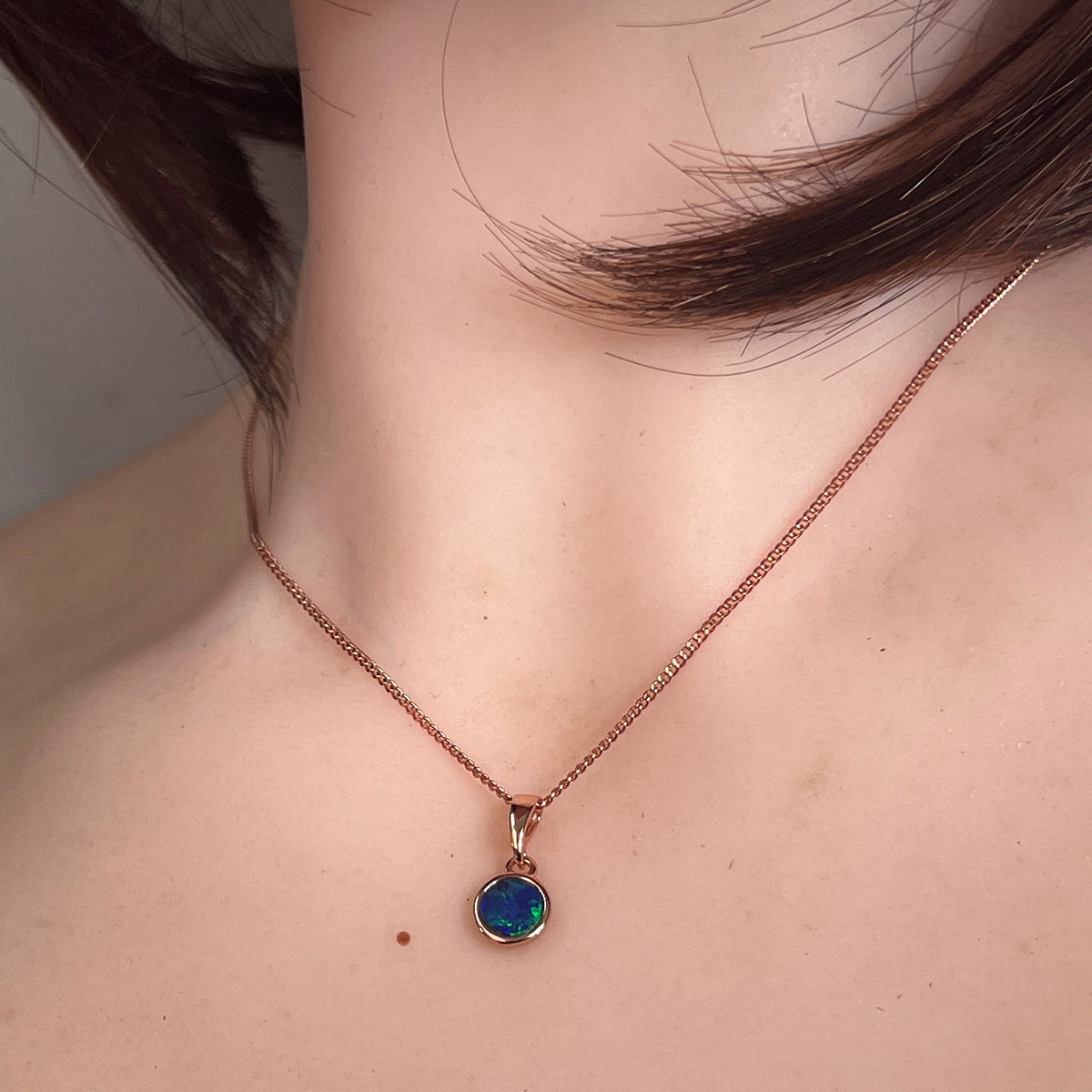 round Australian opal doublet pendant worn, rose gold-plated silver, green, red and blue