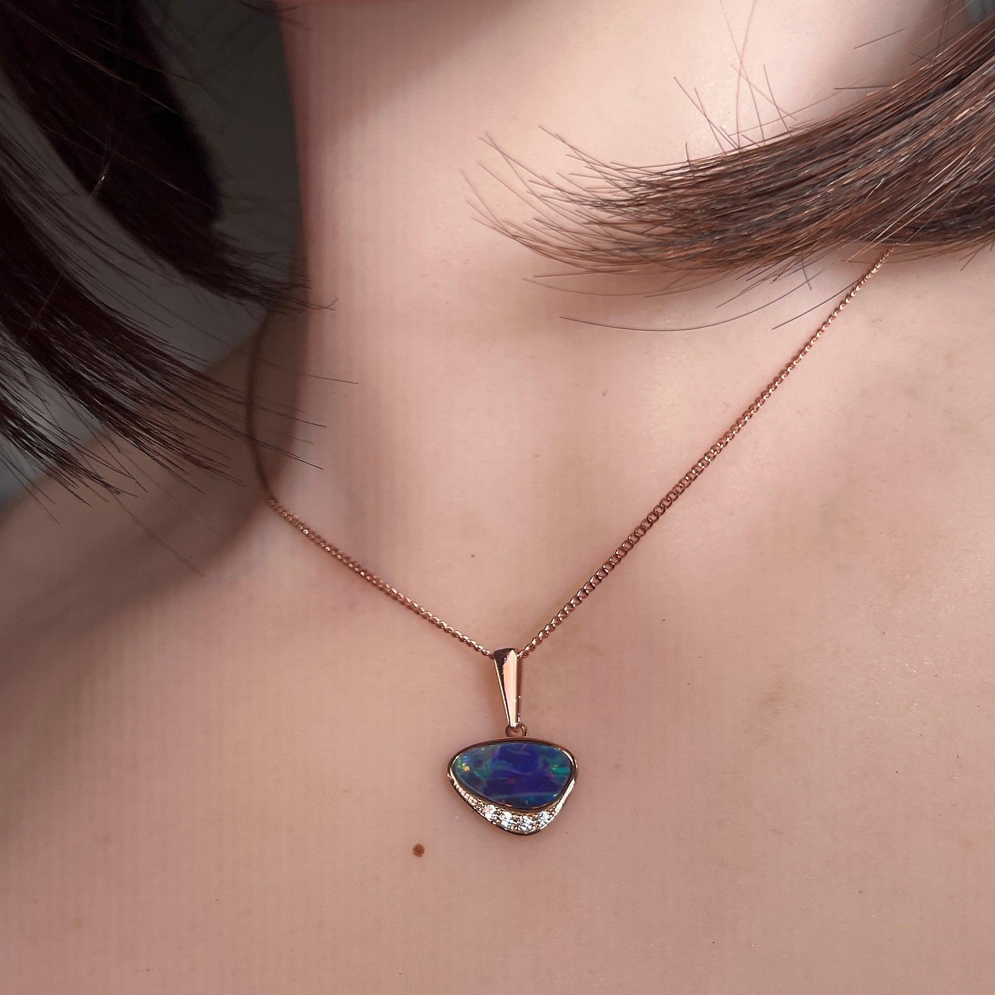Worn Australian opal doublet pendant in rose gold-plated silver, blue, yellow, green and red, 13 x 7mm