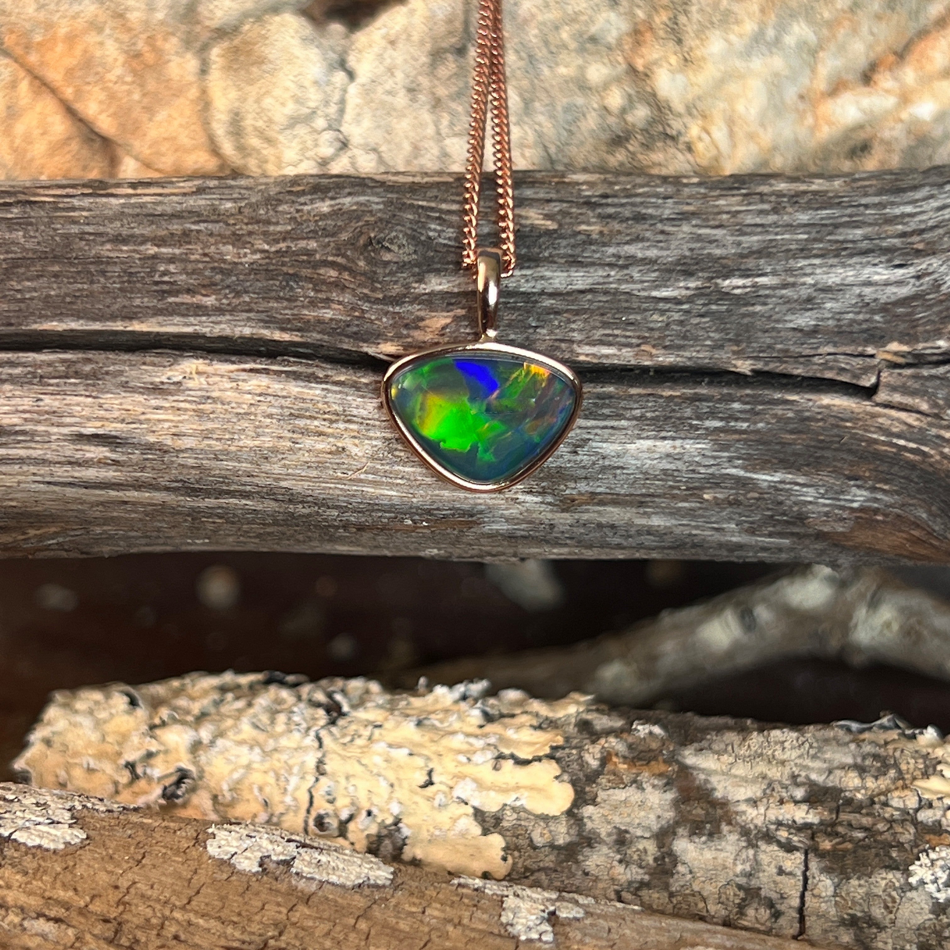 freeform Australian opal triplet pendant in rose gold-plated silver, red, blue, green and yellow play-of-colour