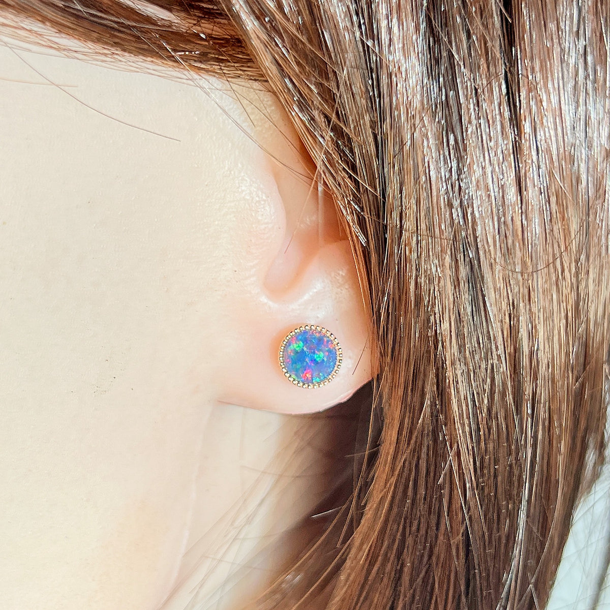 7mm round Australian opal triplet earrings worn on the ear, rose gold-plated silver