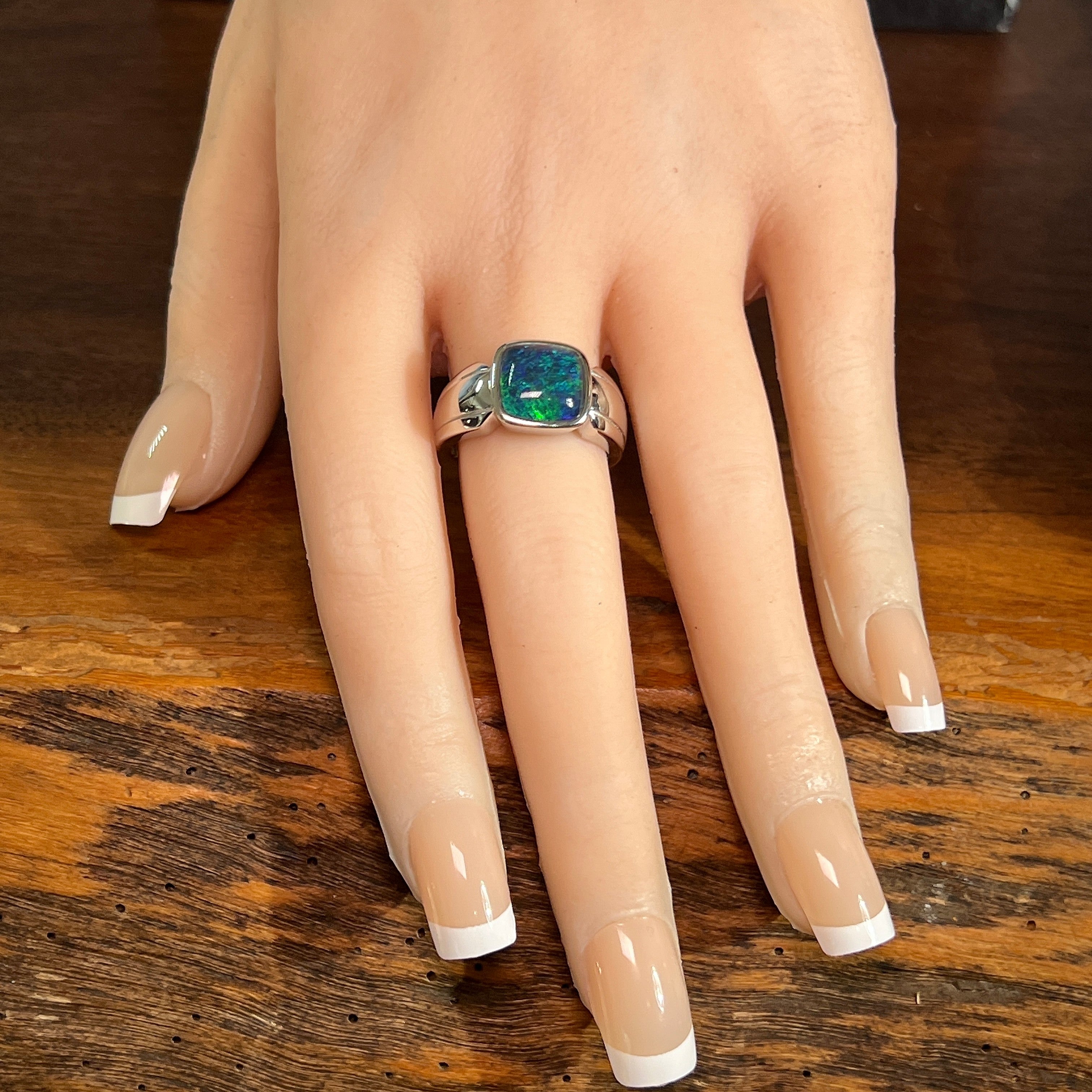 cushion-shaped Australian opal triplet ring in sterling silver, worn on the hand