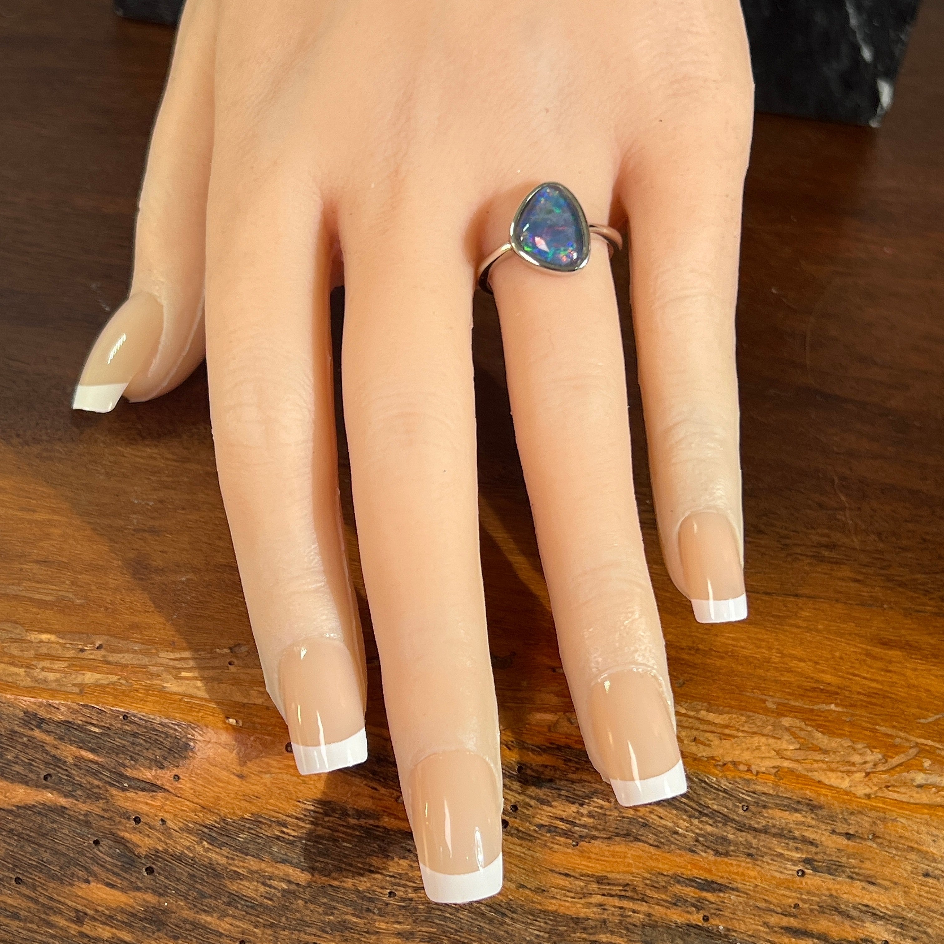 Australian opal triplet ring on the hand, sterling silver, 12.5 x 9.5mm triangular stone