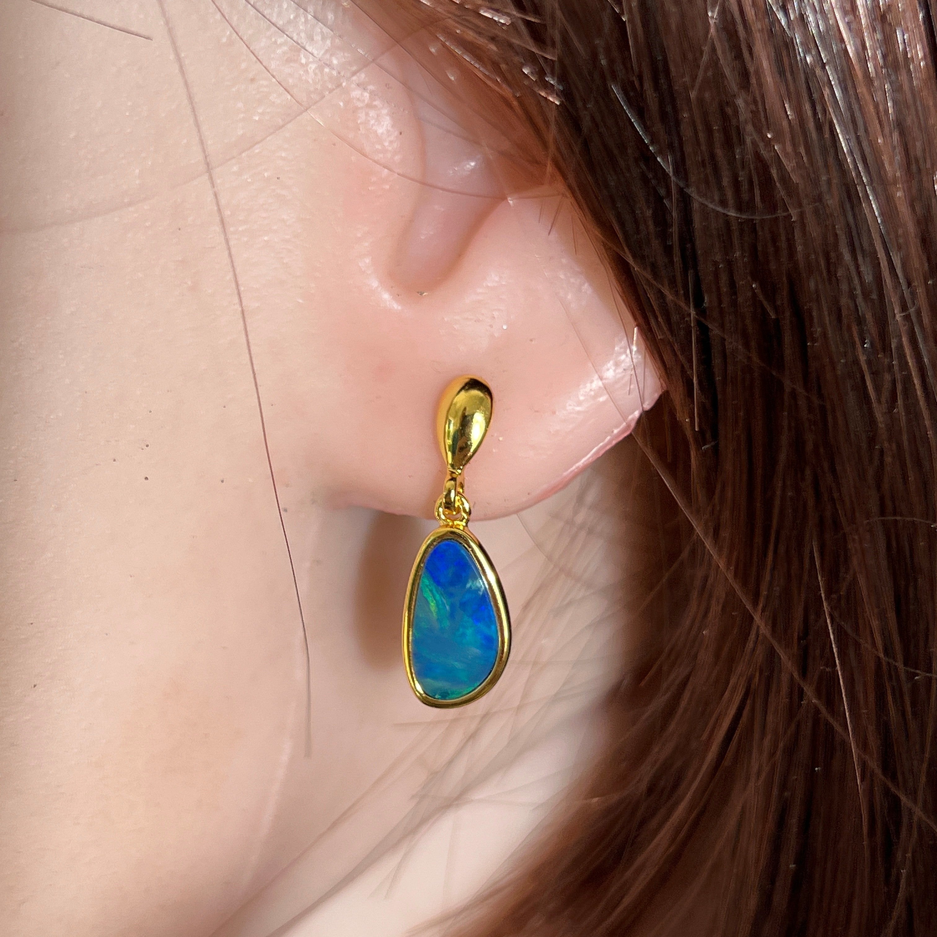 12 x 7mm freeform Australian opal doublet earrings worn on the ear, yellow gold-plated silver