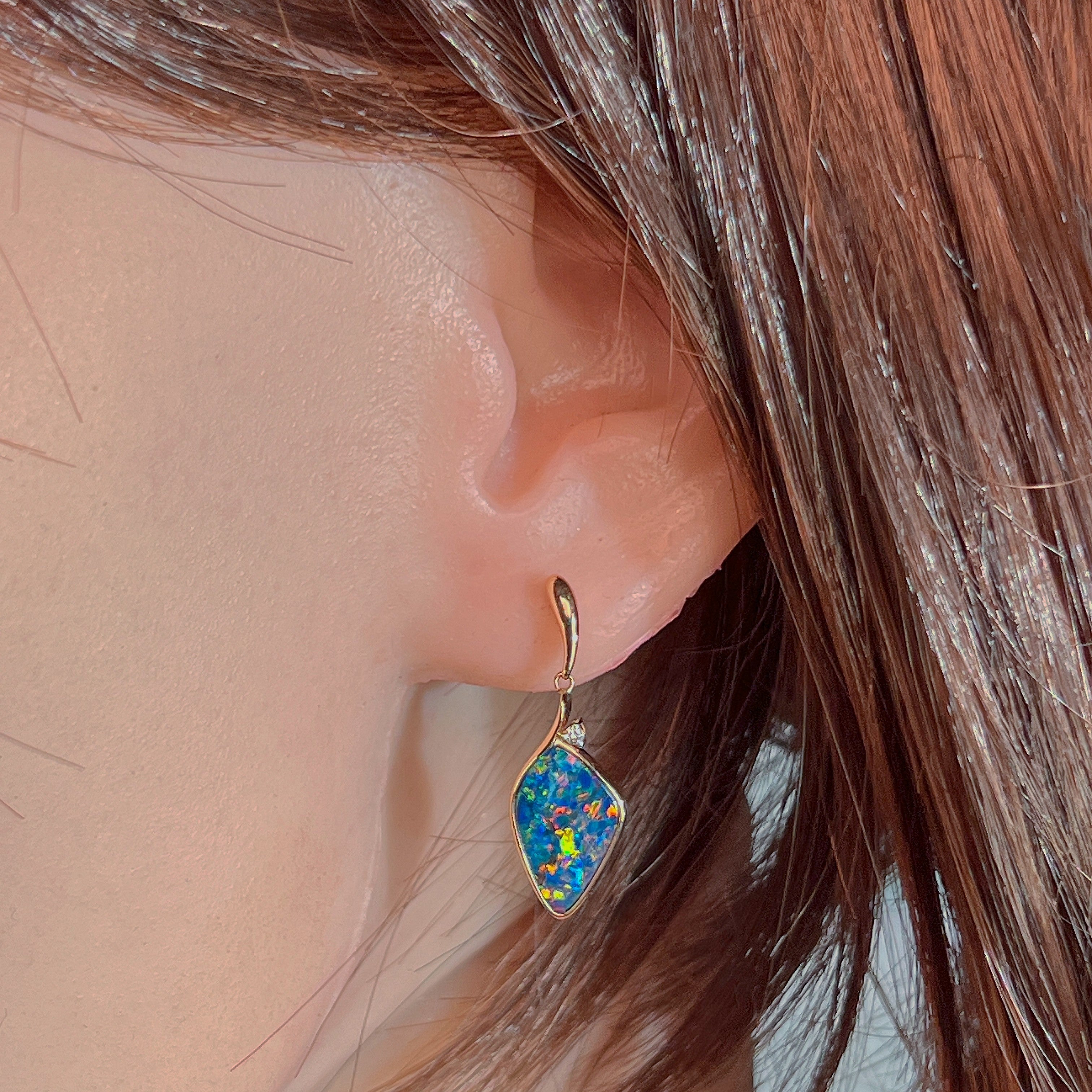 14kt rose gold opal doublet drop earring worn on the ear, showing its scale