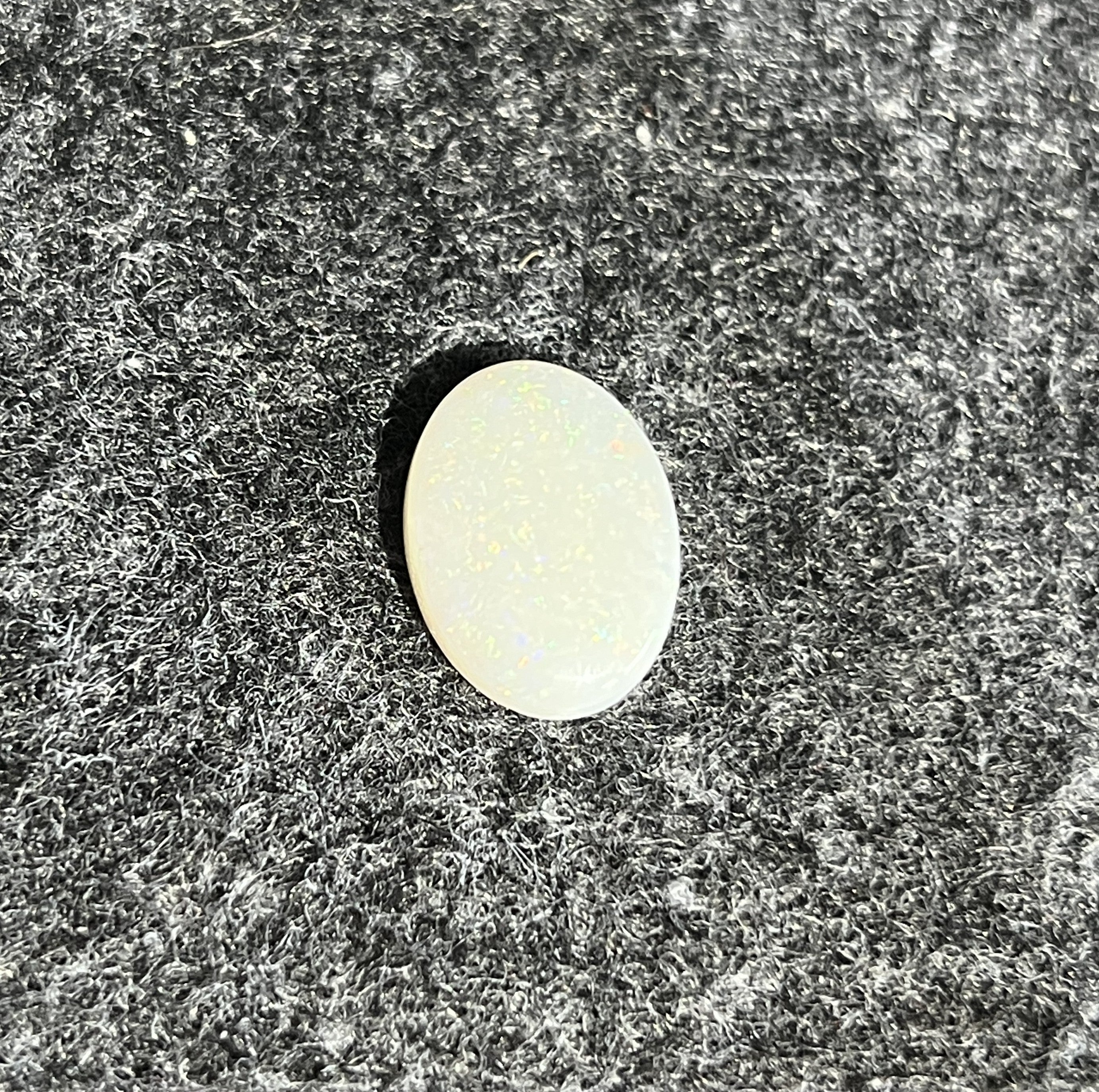 Natural Australian white opal, 5.15ct oval cabochon 16x12mm, milky body with a soft sheen