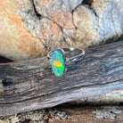 Oval black opal ring, 13.1 x 6.7mm Australian black opal set in 18kt white gold with two diamonds