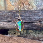 Triangular crystal opal pendant in 9kt yellow gold on a fine gold chain