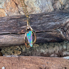 0.51ct Australian crystal opal set in an open 9kt yellow gold pendant frame