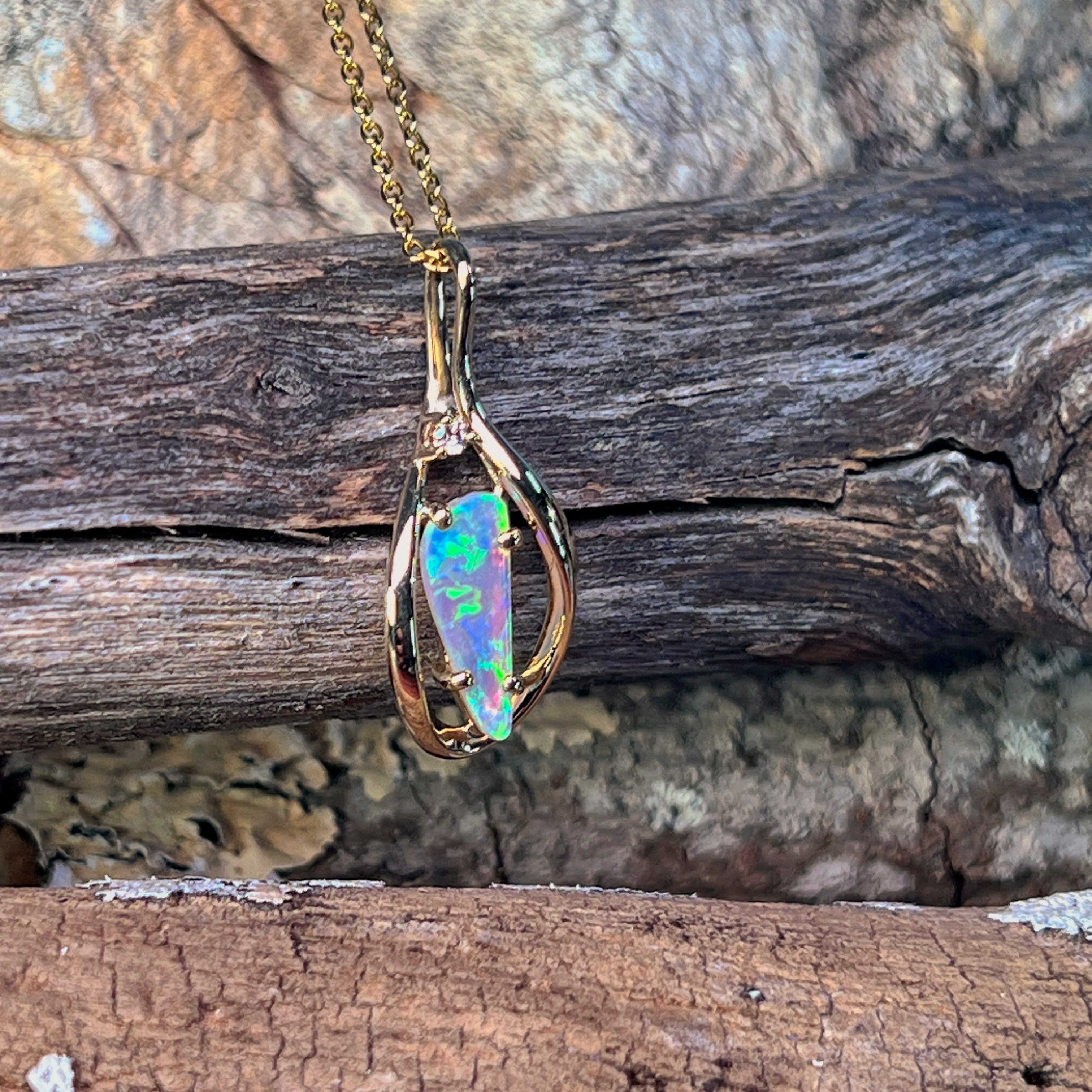 0.51ct Australian crystal opal set in an open 9kt yellow gold pendant frame