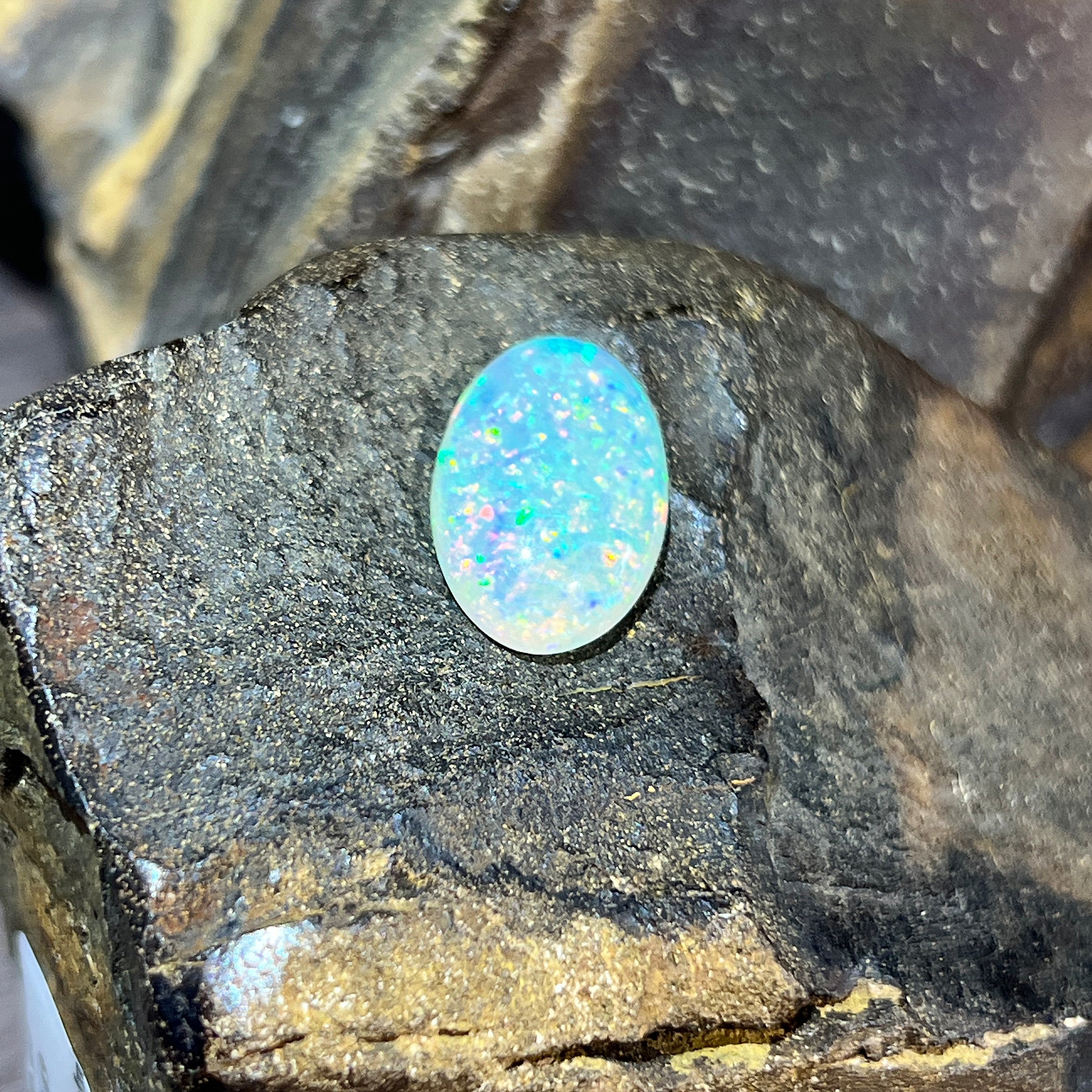 Upright 5.54ct crystal opal showing dense blue-green and orange pinfire