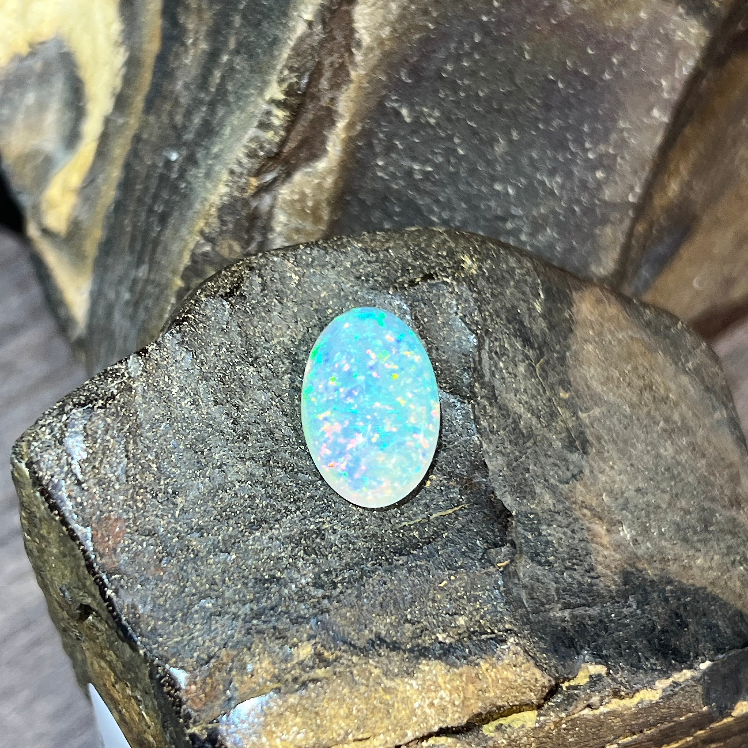 Crystal opal 5.54ct upright, blue green and pink pinfire showing through the stone
