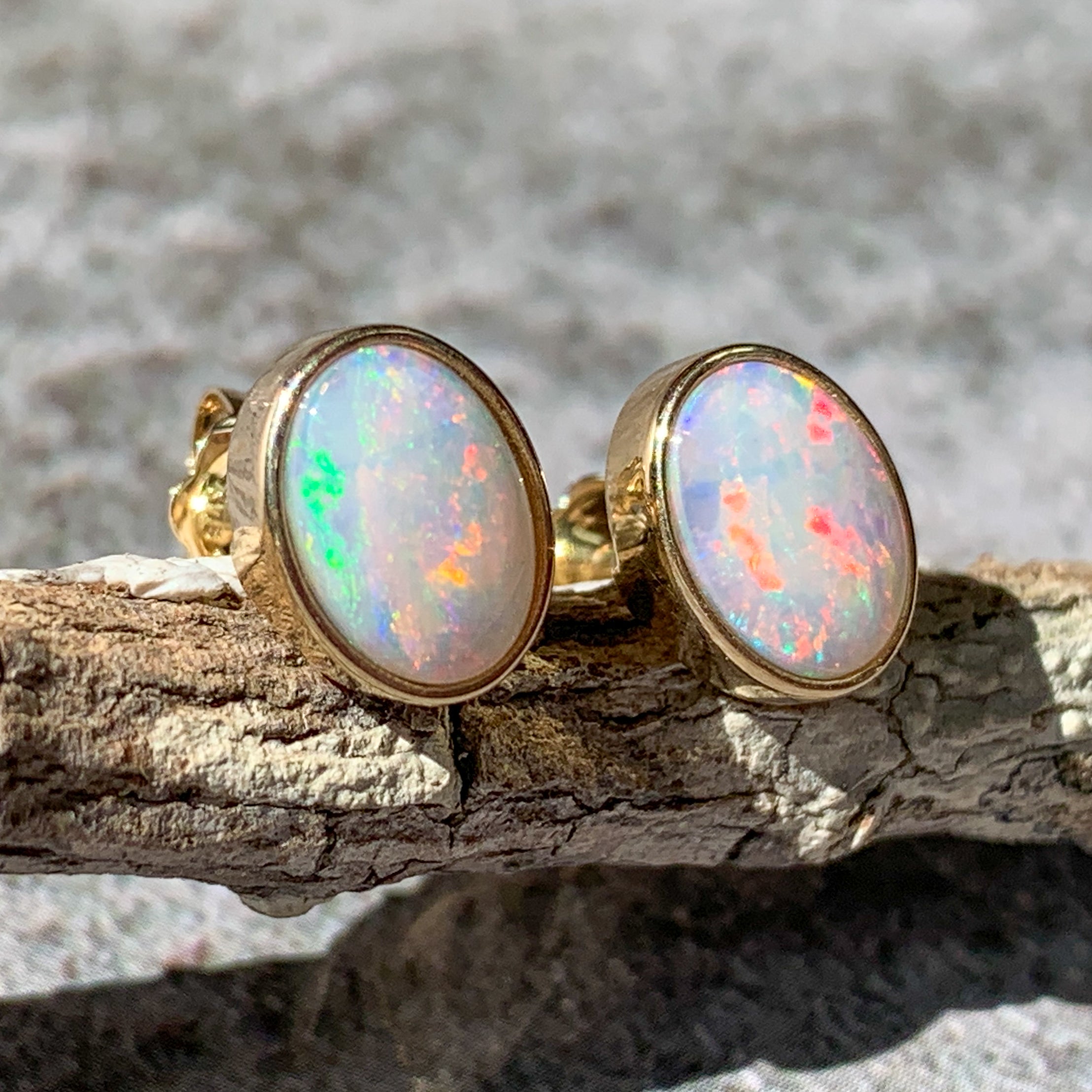 One pair of 9kt Yellow Gold Light Opal earring studs 7x5mm bezel set - Masterpiece Jewellery Opal & Gems Sydney Australia | Online Shop