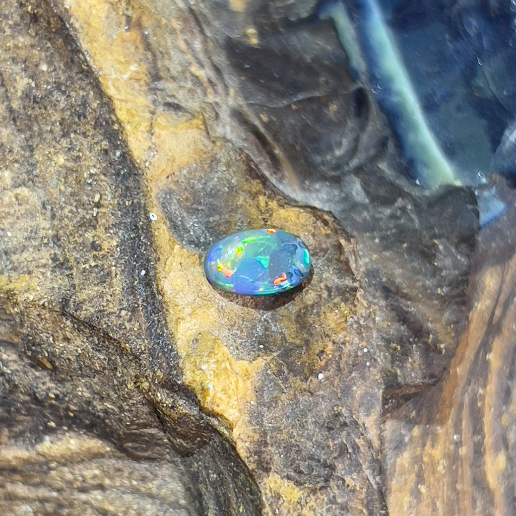 One Oval Black Opal 0.65ct Green, Yellow Orange - Masterpiece Jewellery Opal & Gems Sydney Australia | Online Shop