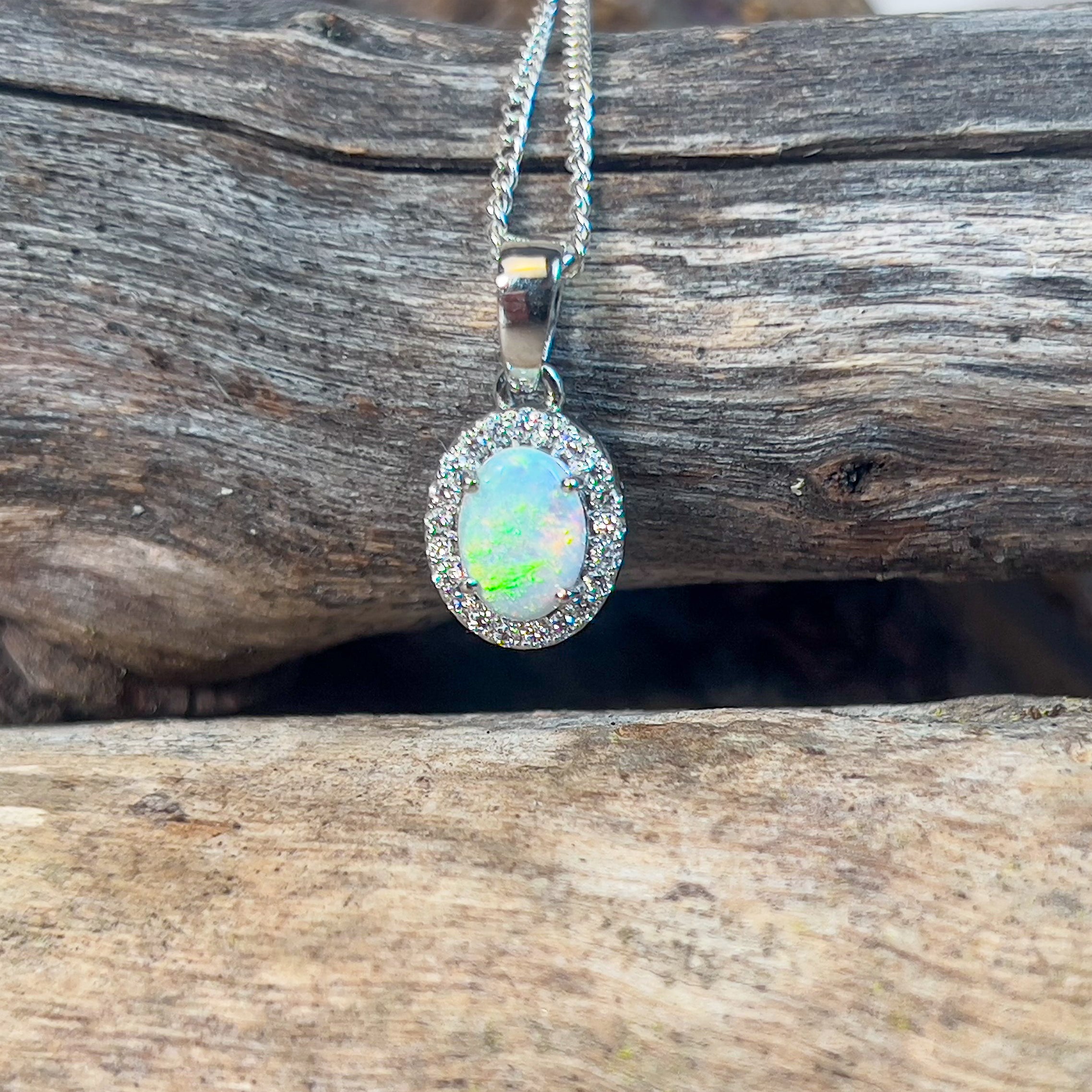 Platinum cluster pendant with one 7x5mm Crystal Opal and Diamond halo - Masterpiece Jewellery Opal & Gems Sydney Australia | Online Shop