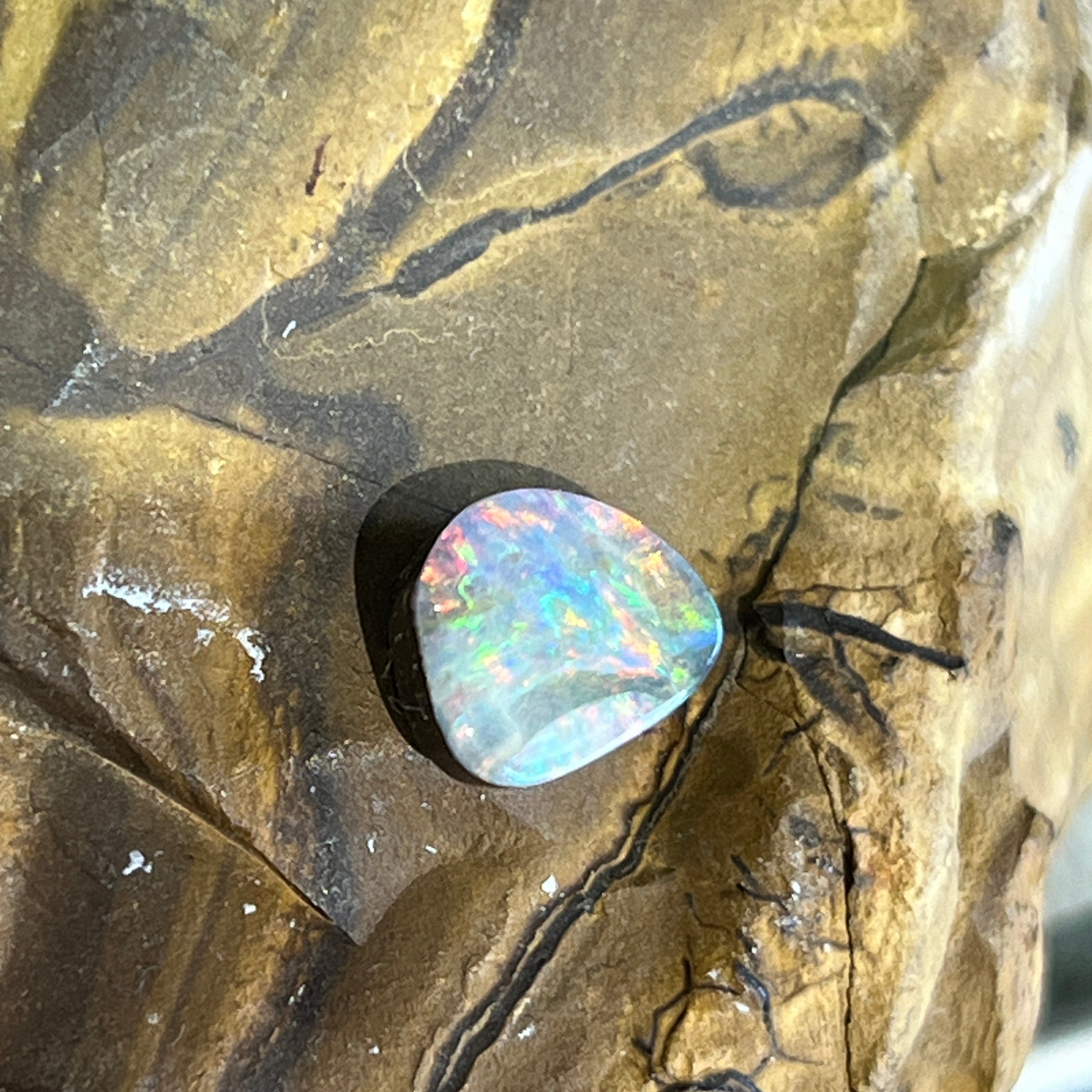 9x7.8mm Australian boulder opal, green and blue play of colour across the lower half