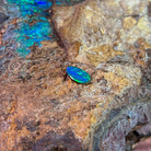 0.65ct Australian opal doublet on ironstone, a green band running through a blue body