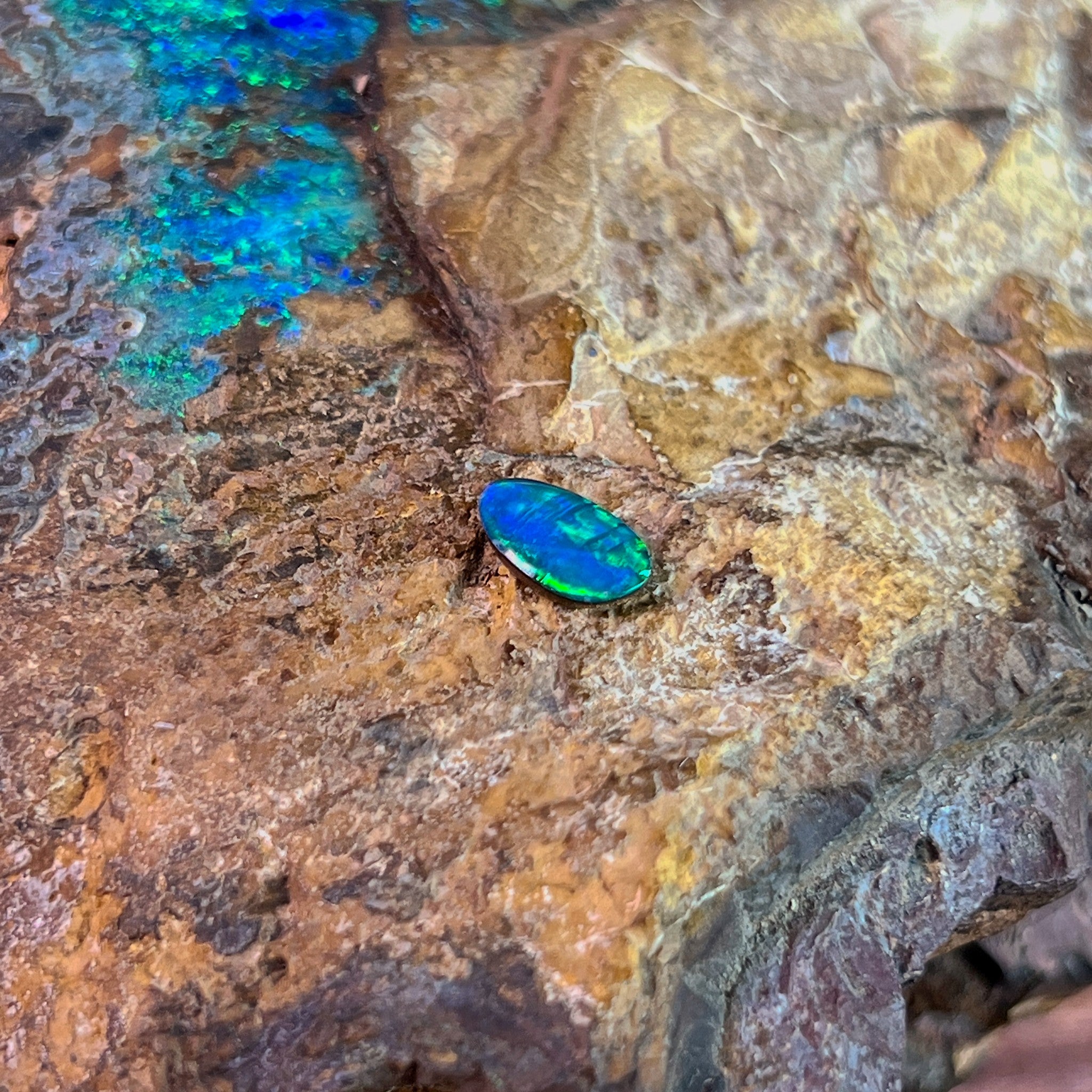 0.65ct Australian opal doublet on ironstone, a green band running through a blue body