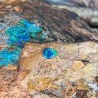 Blue violet and green play-of-colour across a small 0.65ct Australian opal doublet