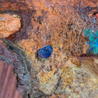 0.78ct Australian opal doublet on ironstone, pinfire specks of red and gold over violet