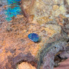 Pinfire play-of-colour scattered across a 0.78ct Australian opal doublet, 8.5x6.2mm