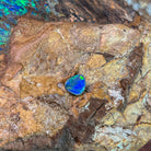 Green and yellow fire in a 0.70ct Australian opal doublet, 7.7x6.4mm, on weathered rock