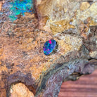 0.91ct Australian opal doublet on ironstone, magenta and green across a blue body