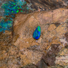Green and yellow flash across a 0.82ct pear shape Australian opal doublet, 10.2x5.7mm