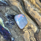 Solid Australian black opal 6.30ct, freeform 18.3x14.4mm, red, orange and green with a blue zone, loose stone on rock