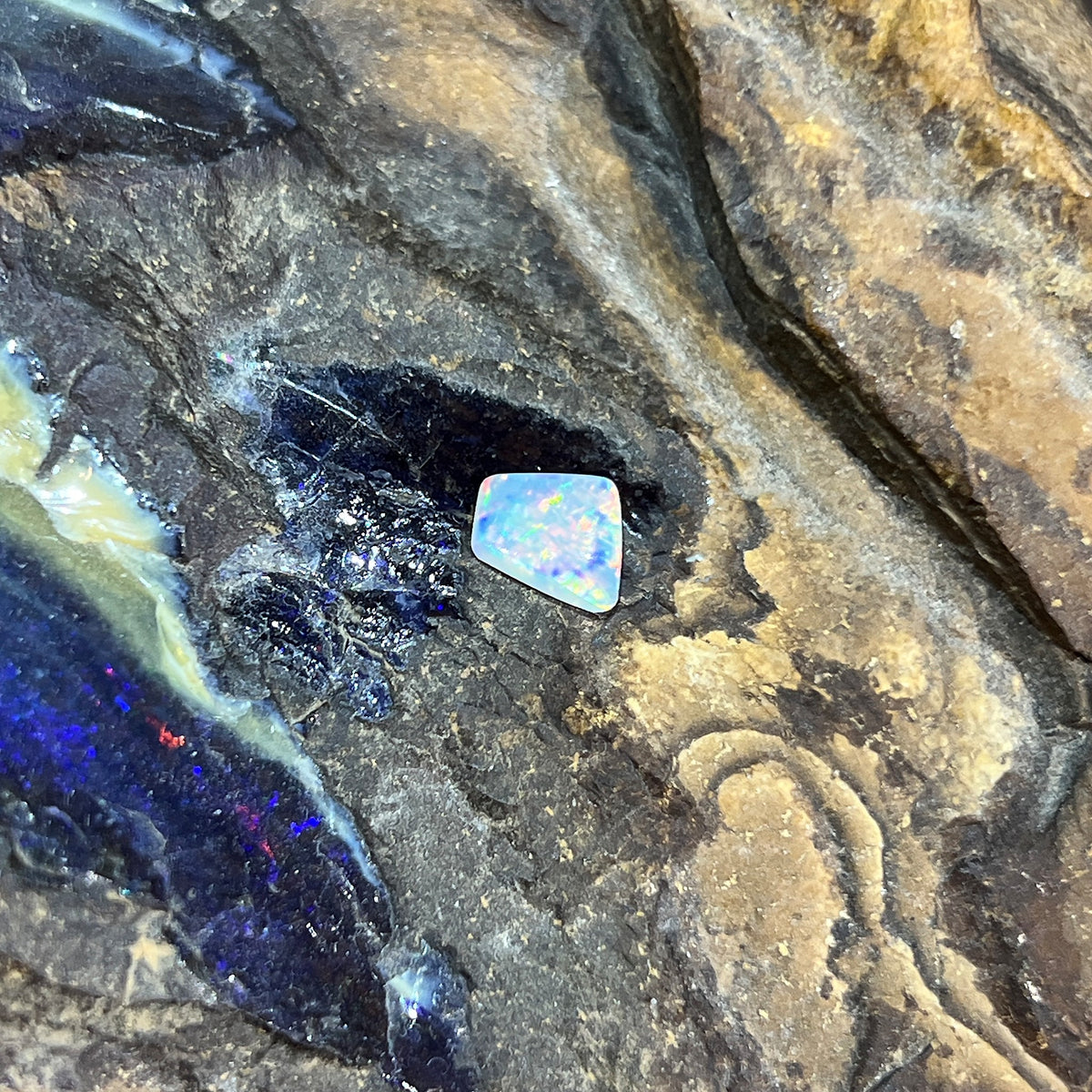 Solid Australian crystal opal 0.65ct, freeform 7.2x6.8mm, red, orange and green flashes, loose stone on rock