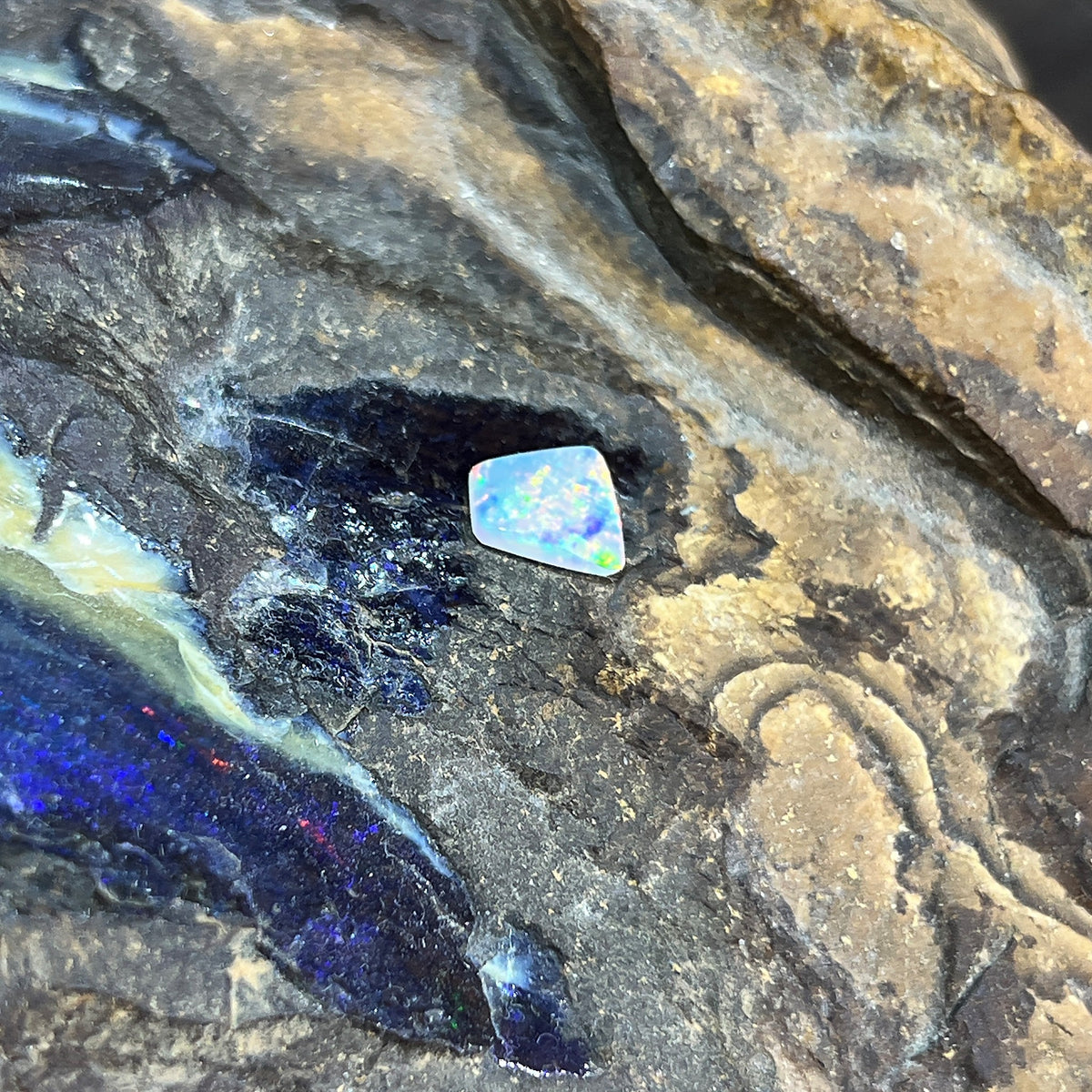 Loose solid crystal opal 0.65ct, freeform, red, orange and green flashes, ready for a custom setting, on rock