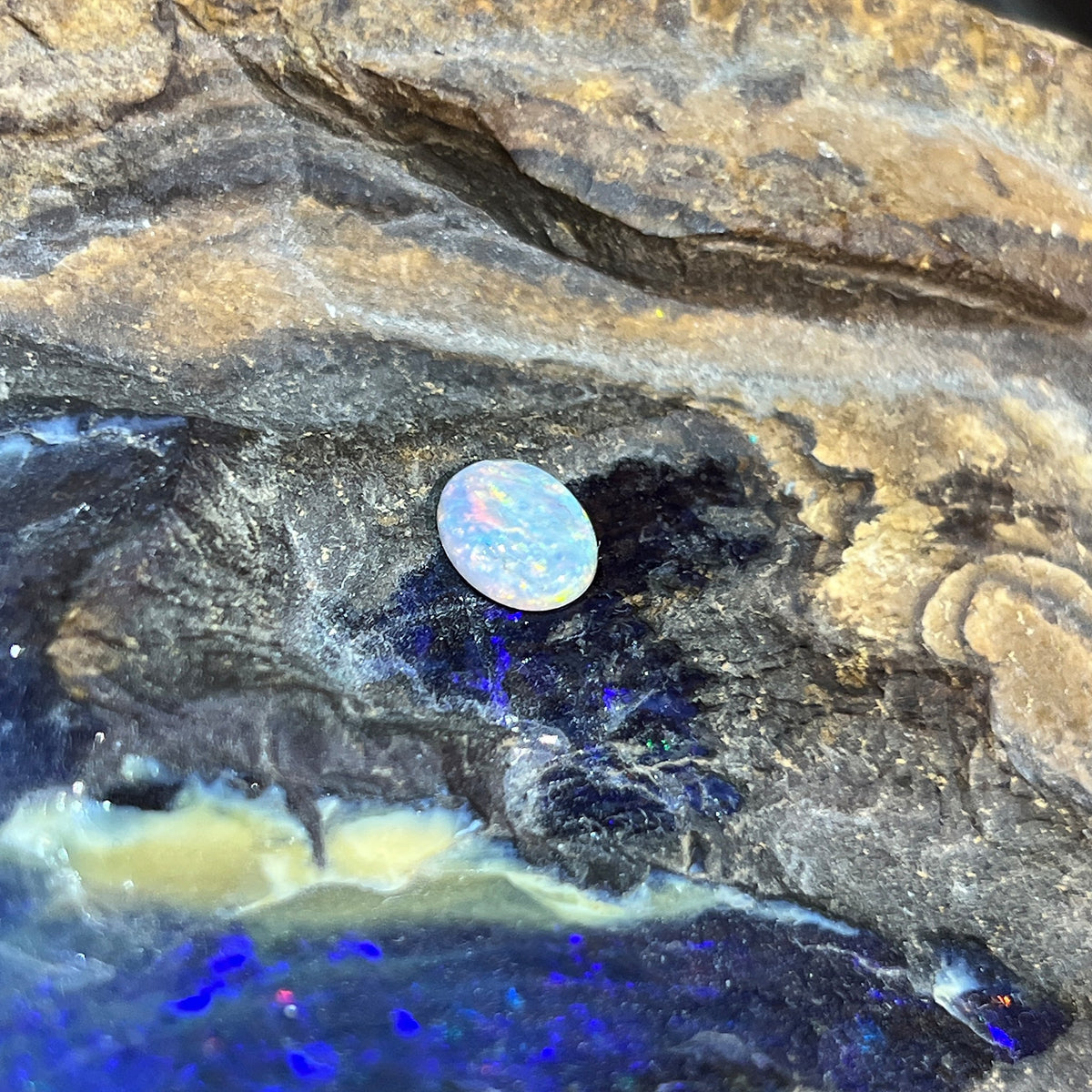 Loose solid black opal 0.85ct, oval, red, orange and yellow flashes, ready for a custom setting, on rock