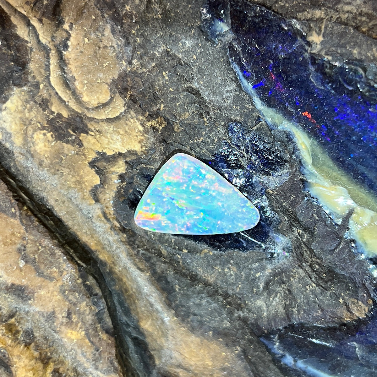 Solid Australian crystal opal 2.15ct, triangular 17x11.4mm, yellow, orange and green with blue zones, loose stone on rock