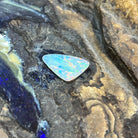 Australian crystal opal 2.15ct triangular cabochon, 17x11.4mm, yellow, orange and green with blue zones, loose and unset, on rock