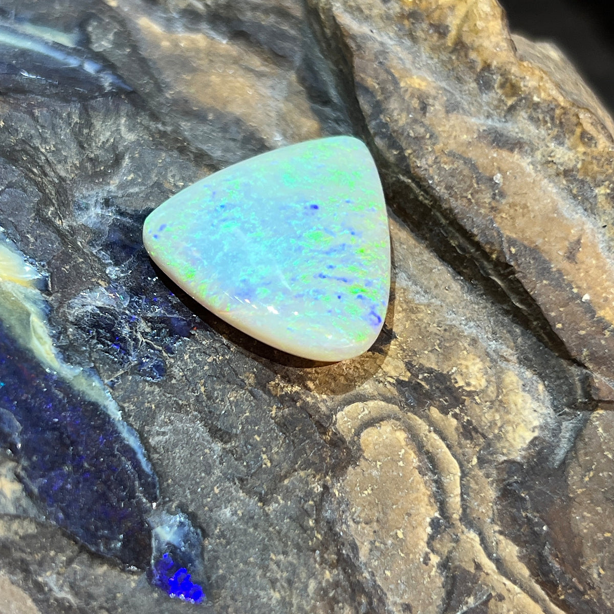 Large 16.50ct solid crystal opal, triangular 23.2x20.7mm, yellow and green play-of-colour, loose stone on rock