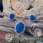 18x13mm oval opal triplet halo pendant in rose gold-plated silver, deep blue-green colour