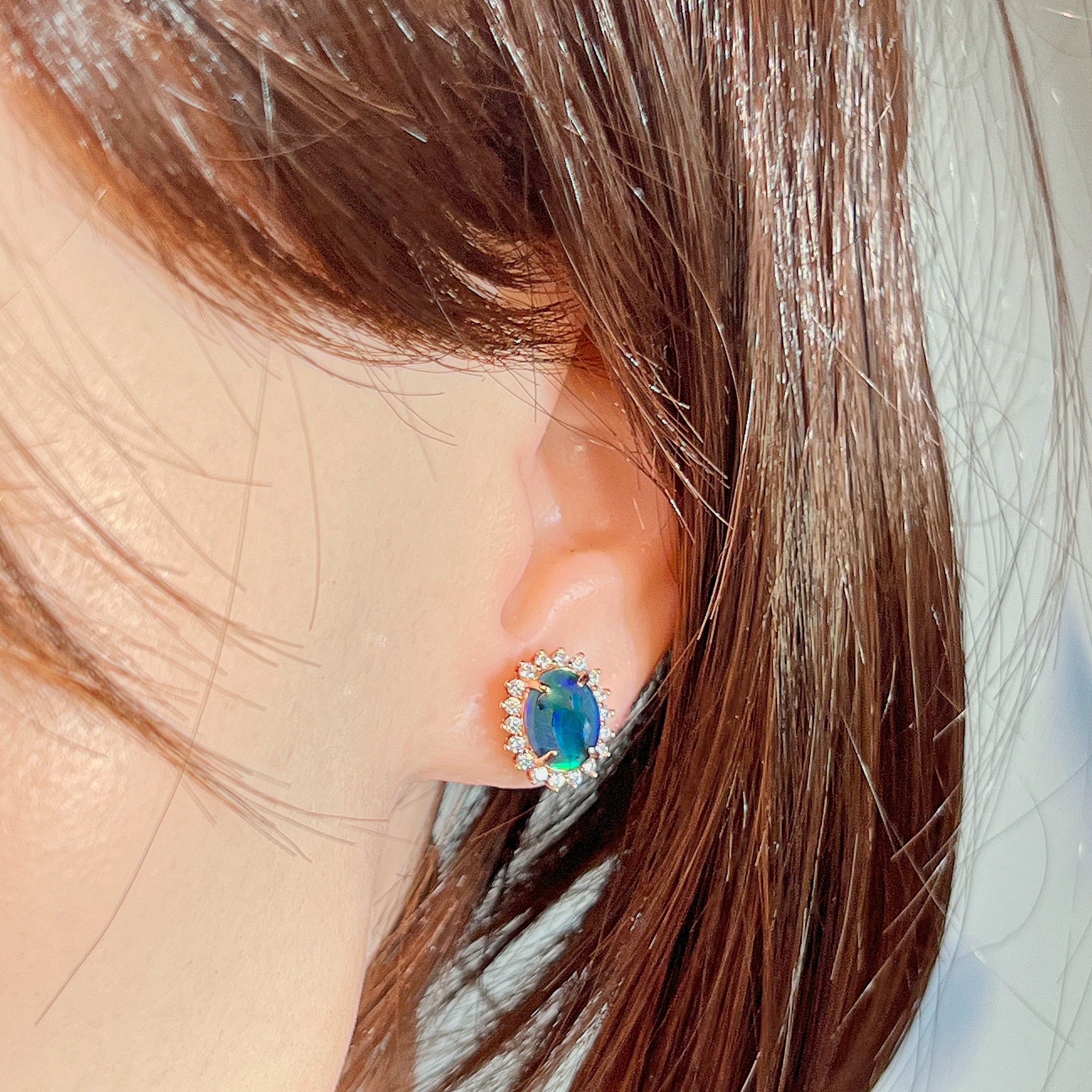 Opal triplet halo cluster earring worn on the ear, side profile view