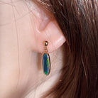 16 x 6mm freeform Australian opal doublet earrings worn on the ear, rose gold-plated silver