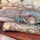 blue, green and red play-of-colour in a 12 x 6mm freeform Australian opal doublet pendant