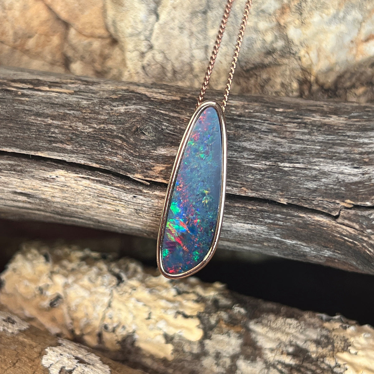 27 x 8mm Australian opal doublet pendant in rose gold-plated silver, red, blue, yellow and green