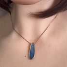 Australian opal doublet pendant worn at the neck, red, blue, yellow and green play-of-colour