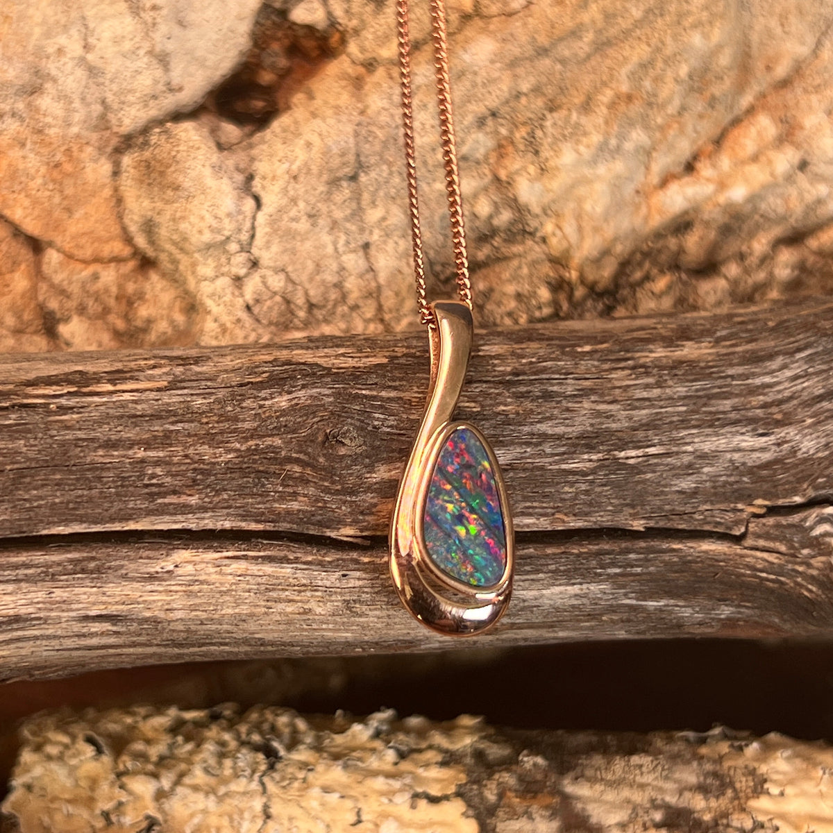 freeform Australian opal doublet pendant in rose gold-plated silver, red, blue and green play-of-colour
