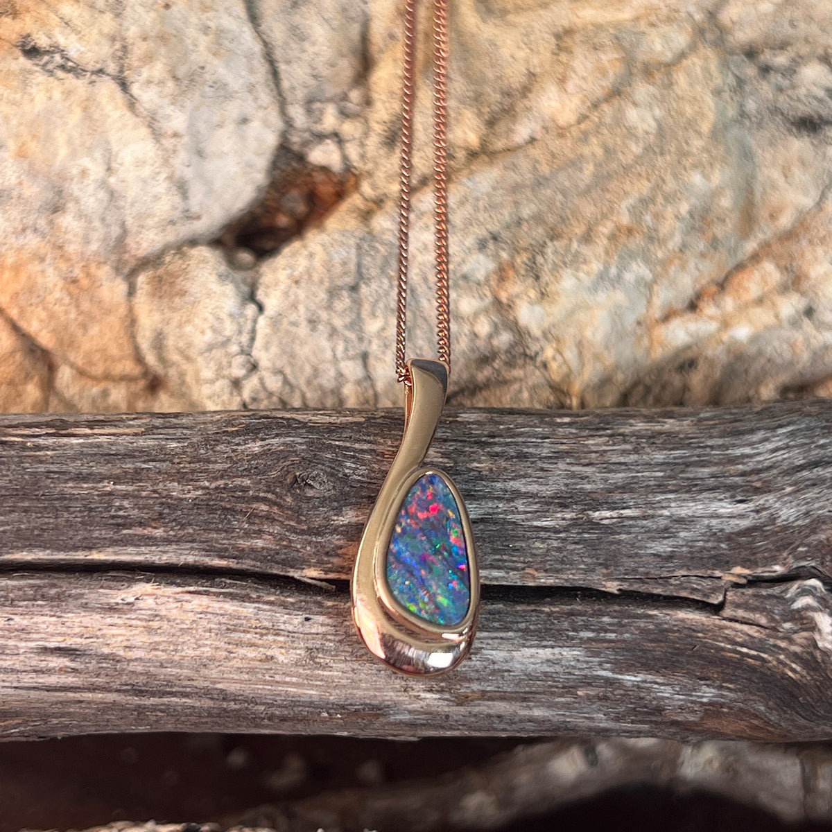 Australian opal doublet pendant, rose gold-plated silver, 12 x 7mm stone showing red, blue and green