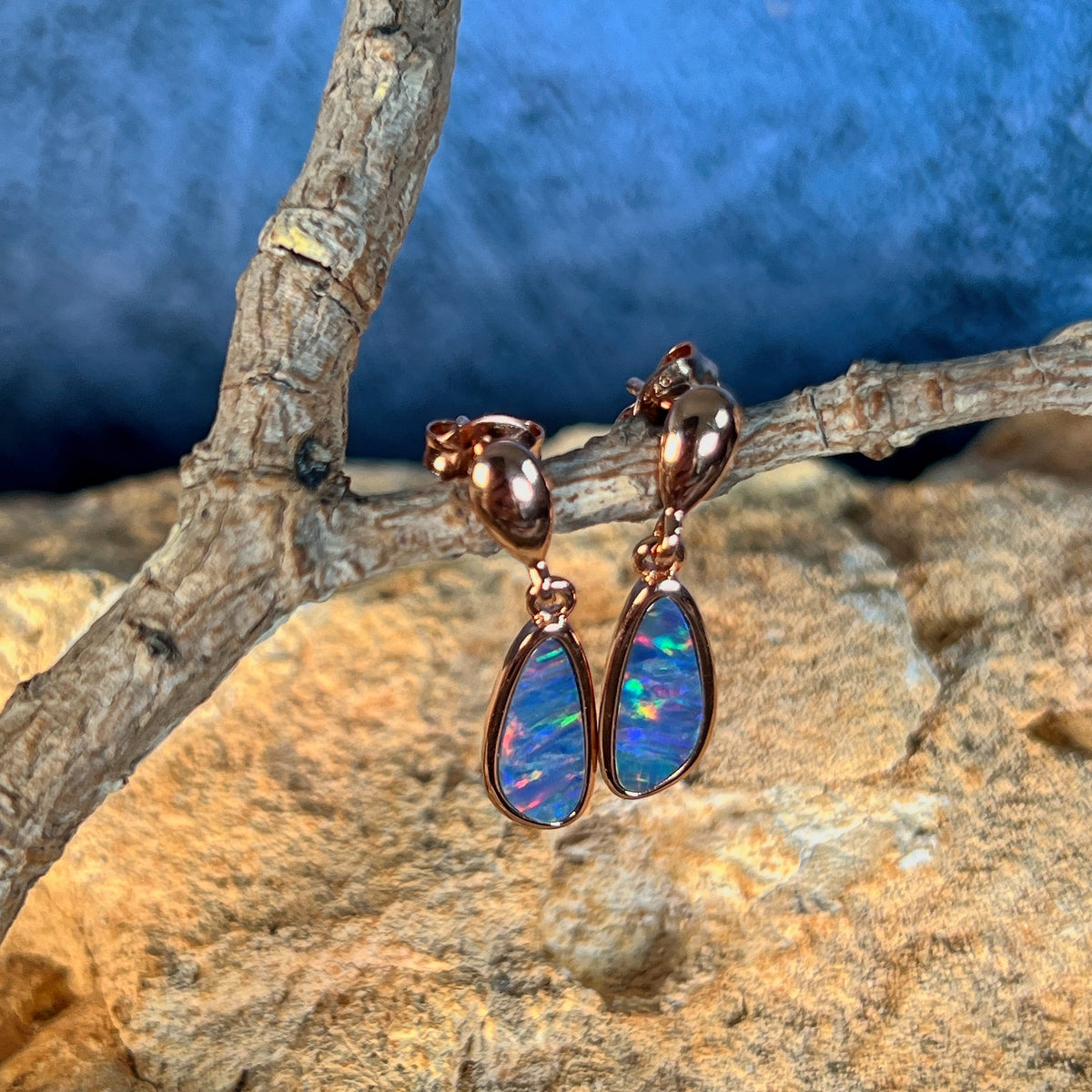 Australian opal doublet earrings, rose gold-plated silver, 13 x 5mm stones showing violet, red, green and blue