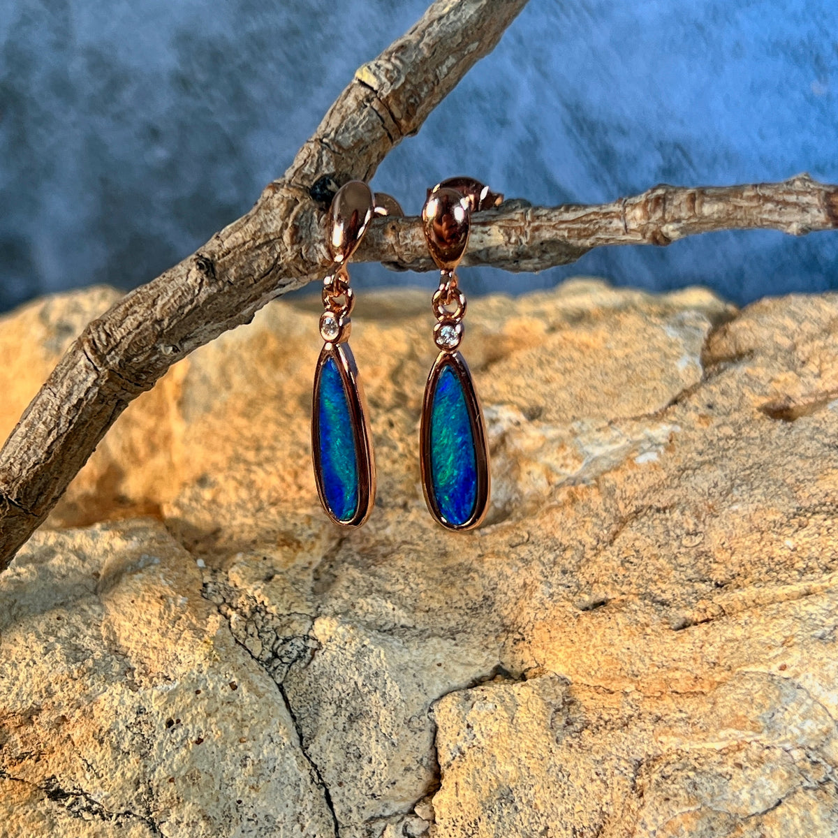 green and blue play-of-colour in 15 x 5mm pear-shaped Australian opal doublet earrings