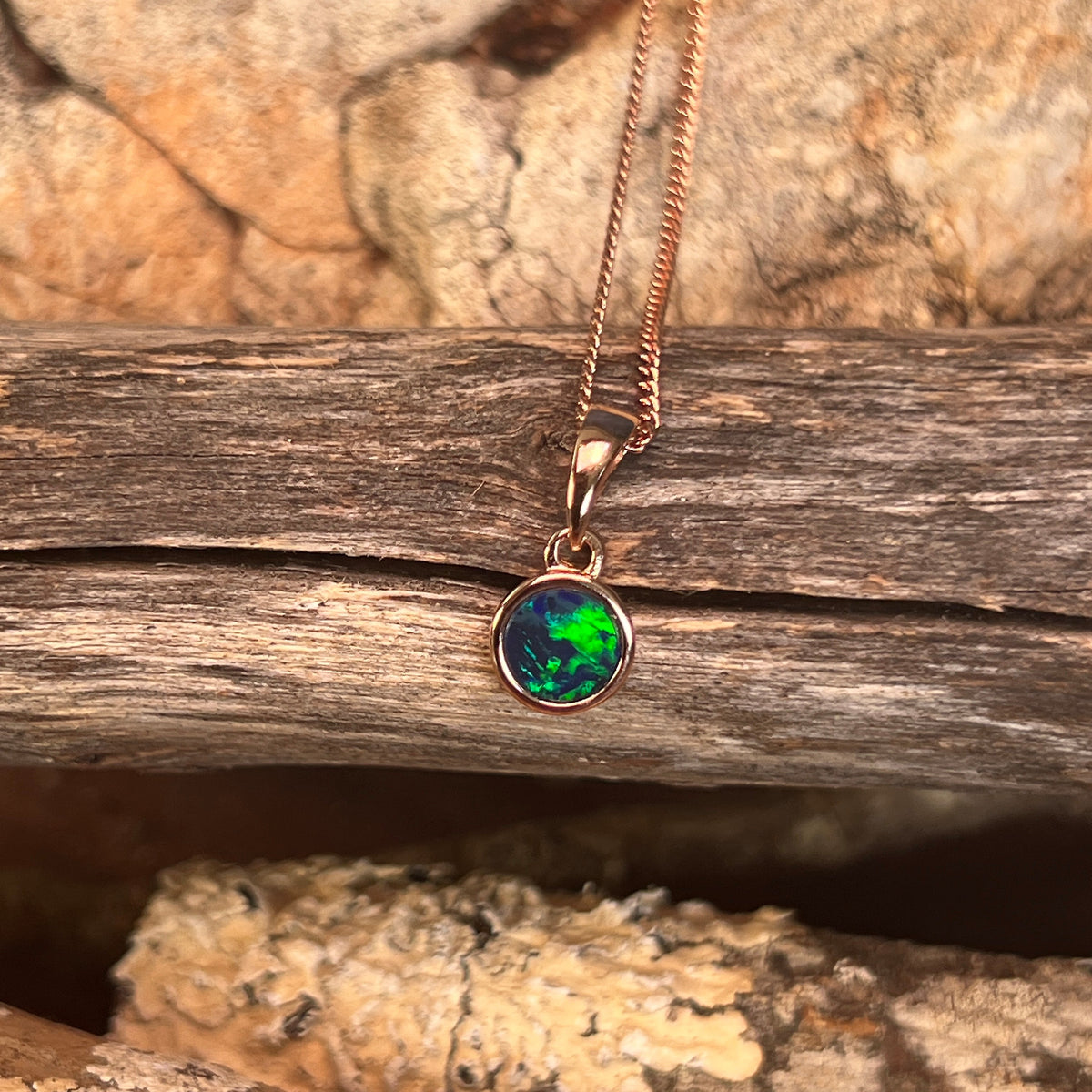 Australian opal doublet pendant, rose gold-plated silver, 6mm stone showing green, red and blue